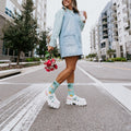 Bird's Eye View tropical themed socks worn on a sunny urban street with palm trees in the background. [lf]