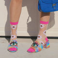 [lf] Model wears sheer daisy socks with bright pink cuffs and eye-adorned rainbow heels.