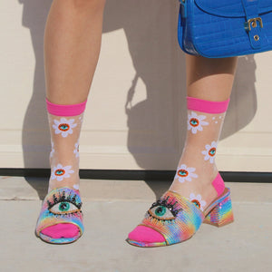 [lf] Model wears sheer daisy socks with bright pink cuffs and eye-adorned rainbow heels.