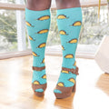 [lf] Model stands wearing blue knee-high socks with taco dinosaur pattern and brown platform heels.