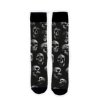 Flat lay showcasing a pair of black crew socks with a skull pattern.