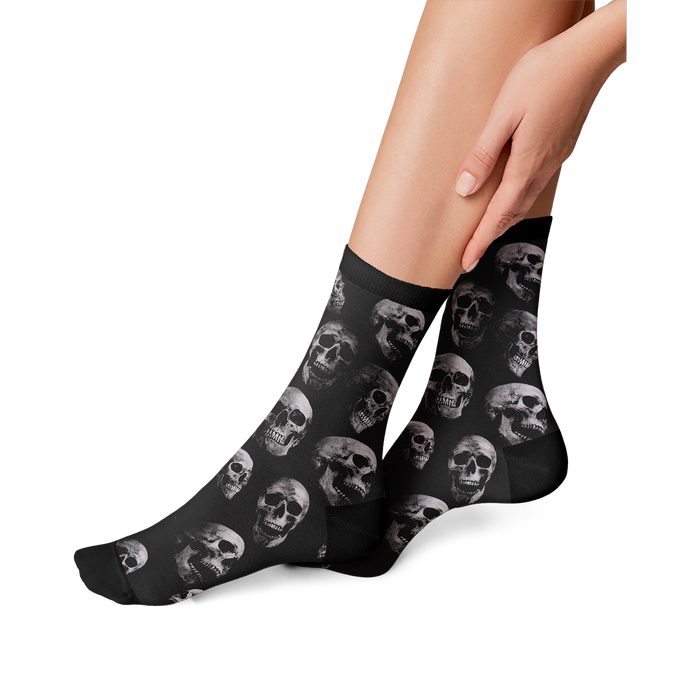 Lifestyle shot: person's legs wearing the skull socks, showing the fit and style.