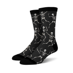 Pair of black crew socks with a fun all-over print of dancing skeletons in off-white.