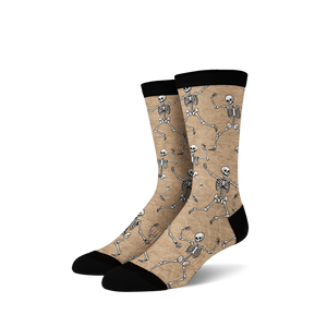 Pair of tan crew socks with a fun all-over print of dancing skeletons in off-white.