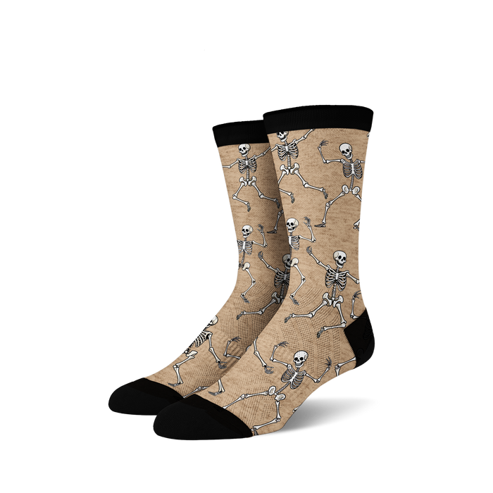 Pair of tan crew socks with a fun all-over print of dancing skeletons in off-white.