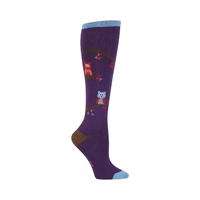 Purple knee-high socks with a whimsical design featuring owls perched on brown branches. Accents of red and blue on the owls and branches.