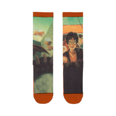 Pair of crew socks showcasing artwork from Harry Potter and the Goblet of Fire. Greens, oranges, and dark tones depict Harry, the Goblet, and other characters.