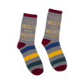 A pair of gray crew socks with maroon, blue, gold, and green stripes. The socks feature the quote: "Books turn Muggles into Wizards."