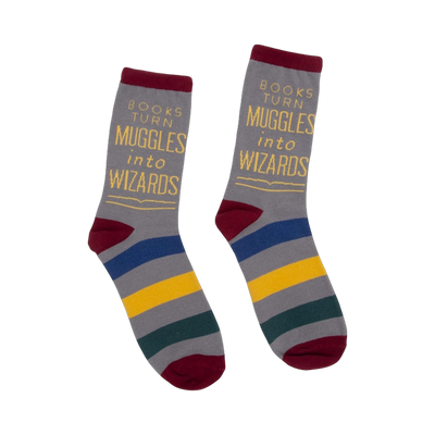 A pair of gray crew socks with maroon, blue, gold, and green stripes. The socks feature the quote: "Books turn Muggles into Wizards."