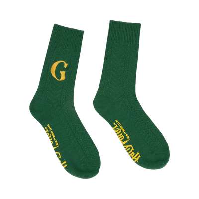 Pair of dark green crew socks with a cable knit texture. One sock displays a golden 'G', the other has 'Fred and George Weasley' in gold lettering.