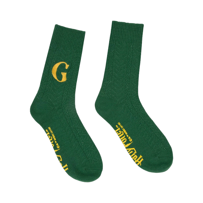 Pair of dark green crew socks with a cable knit texture. One sock displays a golden 'G', the other has 'Fred and George Weasley' in gold lettering. }}