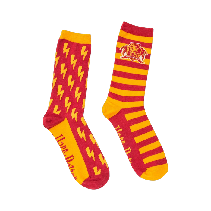 Pair of red and gold Gryffindor socks. One sock has a lightning bolt pattern, the other has the Gryffindor crest and stripes. }}