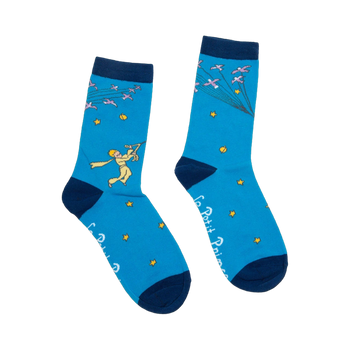 Pair of blue crew socks with navy cuffs.  Features The Little Prince illustration, flock of birds, and gold stars. 