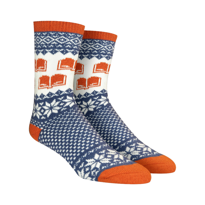 Pair of crew socks in navy blue, white, and burnt orange. Features a Fair Isle pattern with snowflakes and repeating book designs. }}