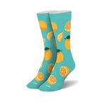 Pair of crew socks. Light teal background with a pattern of yellow lemons and lemon slices. 