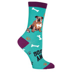Close-up of a teal sock with a bulldog, bones, and paw prints.