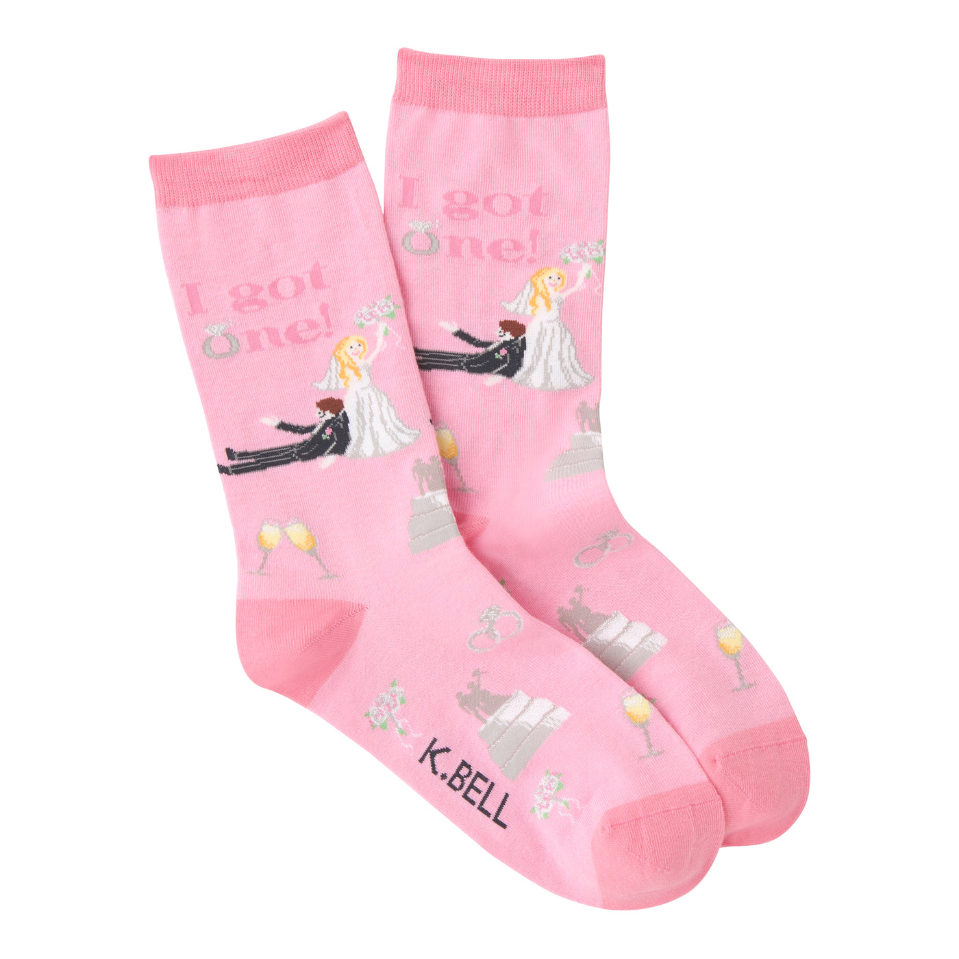 A pair of pink crew socks. The socks have a wedding theme with illustrations of a bride and groom, rings, cake, and champagne glasses. Text reads: 'I got one!'