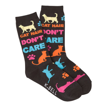 A pair of dark-colored crew socks with a playful design. The socks feature colorful cat silhouettes, paw prints, and the text 'Cat Hair Don't Care'.
