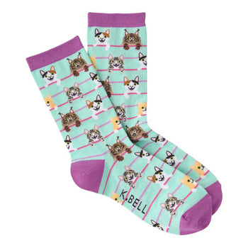 Crew socks in mint green with purple cuffs.  The design features an all-over pattern of illustrated cats of various colors, peeking over pink stripes.