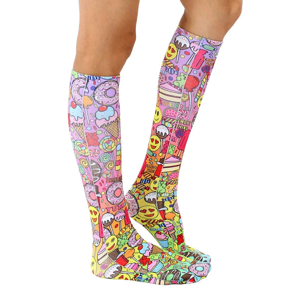 Lifestyle shot of a person wearing the 'I Want Candy' knee-high socks, showing how they look when worn. [lf]