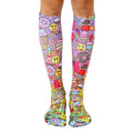 Knee-high socks with a colorful candy-themed print. Pink, purple, and yellow are prominent, featuring donuts, ice cream, and smiley faces. [lf]
