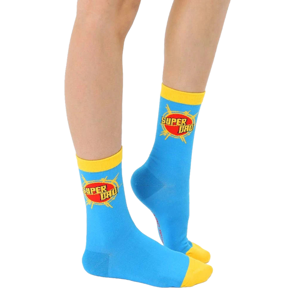 Flat lay of adult 'Super Dad' socks. Blue with yellow cuff and graphic. [lf]