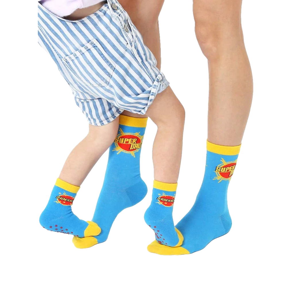 Adult and child crew socks. Blue with yellow cuffs. 'Super Dad' and 'Sidekick' graphics. [lf]