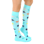 Lifestyle shot showing the Under The Sea Compression socks on a person's legs. [lf]