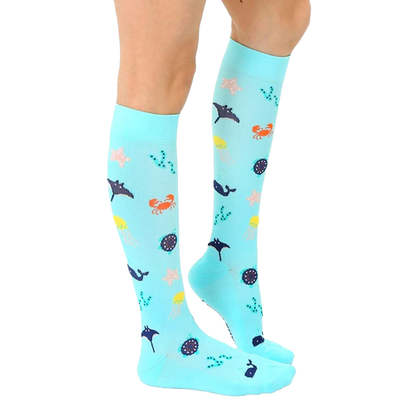 Lifestyle shot showing the Under The Sea Compression socks on a person's legs. [lf]