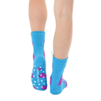 Close-up view of the back of the light blue fuzzy monster slipper socks, showing the non-skid grips on the soles. [lf]
