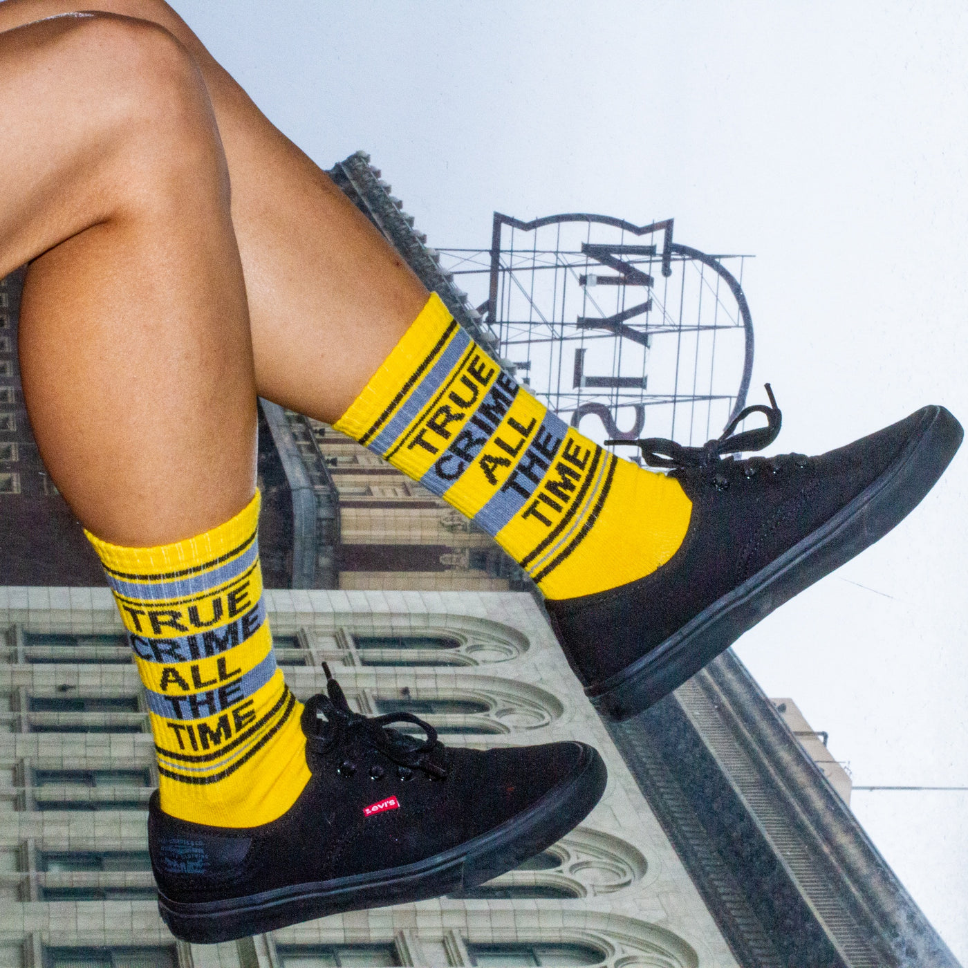 Another lifestyle shot showcasing the True Crime socks on a person's feet, this time with the socks slightly higher up the leg. [lf]