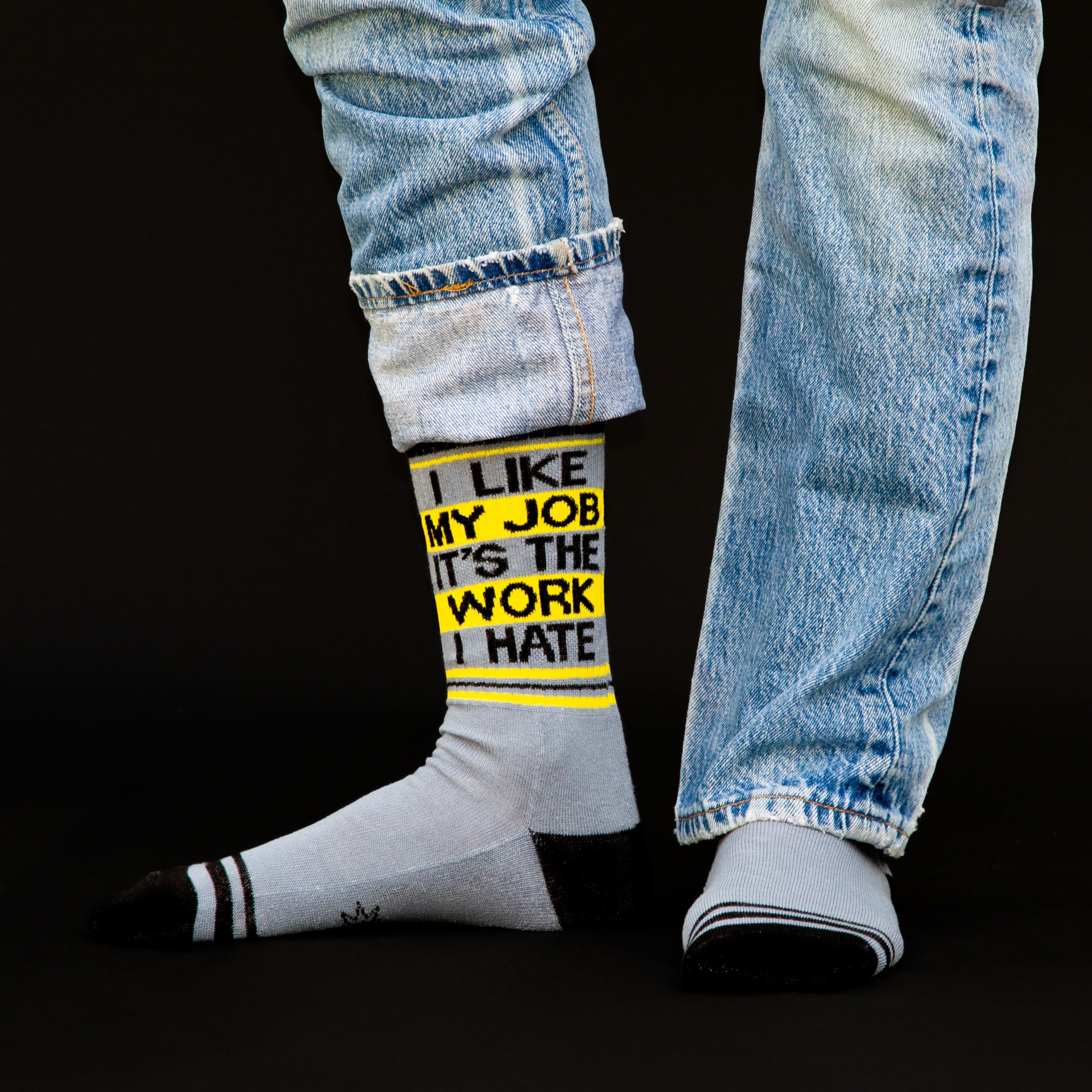 Lifestyle shot showing the socks on a person's feet with jeans; black background.