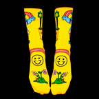 Flat lay: Pair of yellow Skate Day socks on a black background. Shows full sock design. [lf]