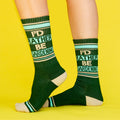 Product shot showing the socks from the side, against a bright yellow background. [lf]