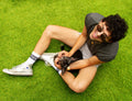 Lifestyle photo: Person wearing the socks, sitting on green grass with a dog. [lf]