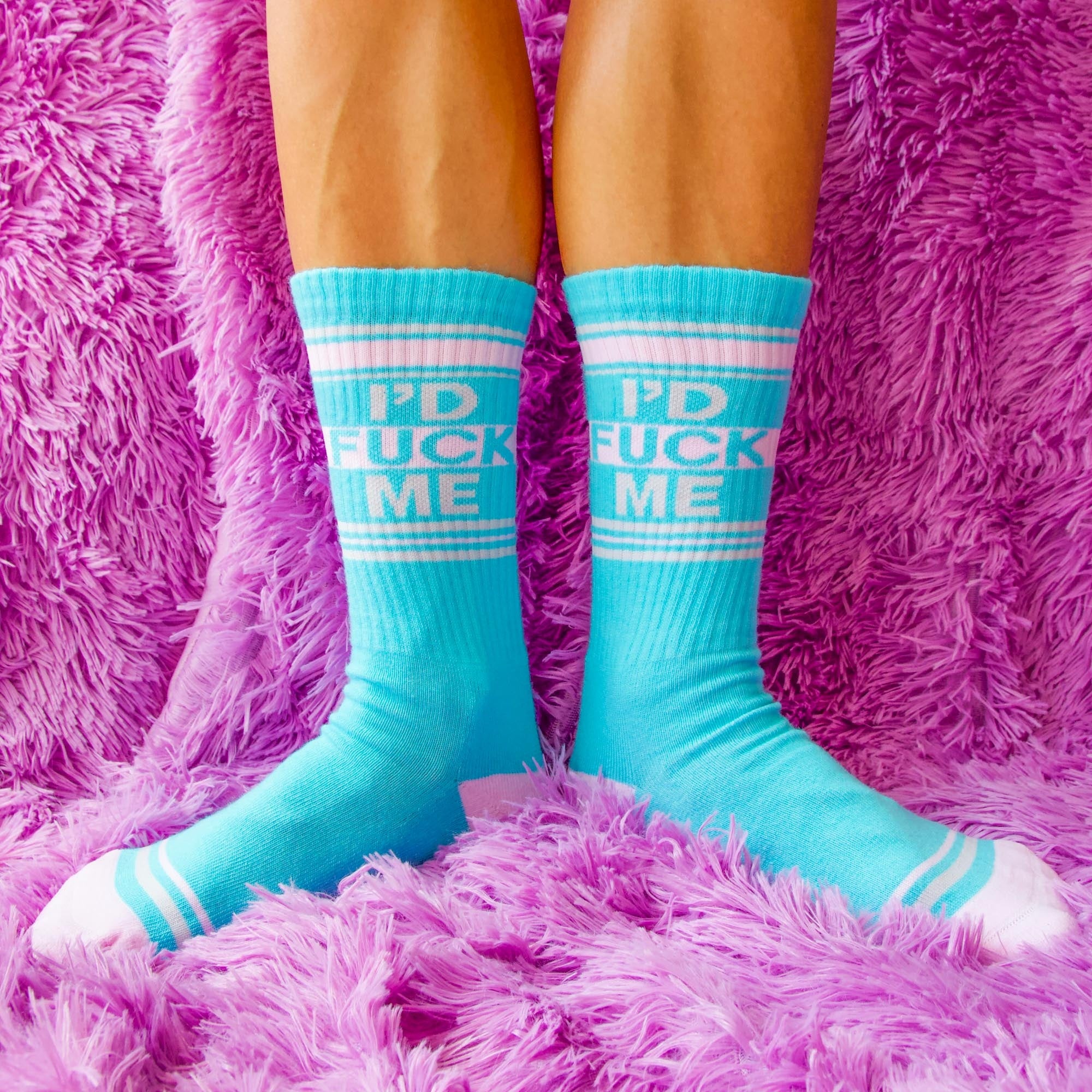 Close-up shot of the socks on a purple fluffy surface. The 'I'D FUCK ME' text is clearly visible. [lf]