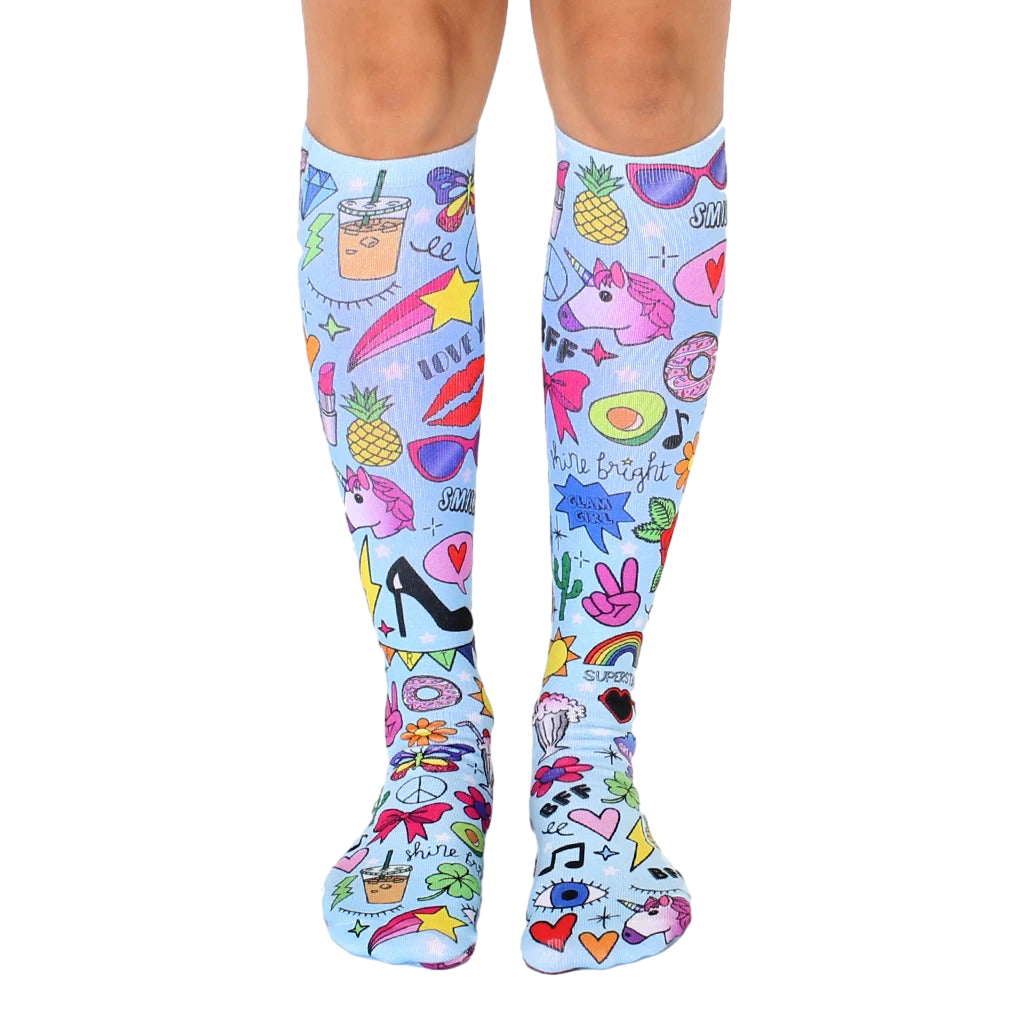 Knee-high socks, light blue background, colorful girly design with unicorns, pineapples, and other fun doodles. [lf]