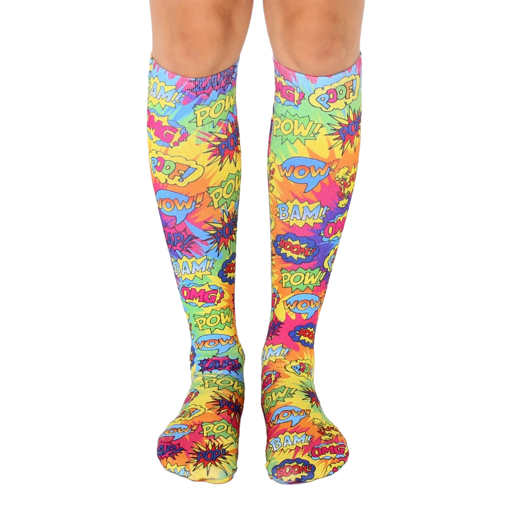 Knee-high socks in a tie-dye pattern of bright yellow, pink, and blue.  Comic book-style words like 'POW!' and 'BAM!' are printed throughout. [lf]