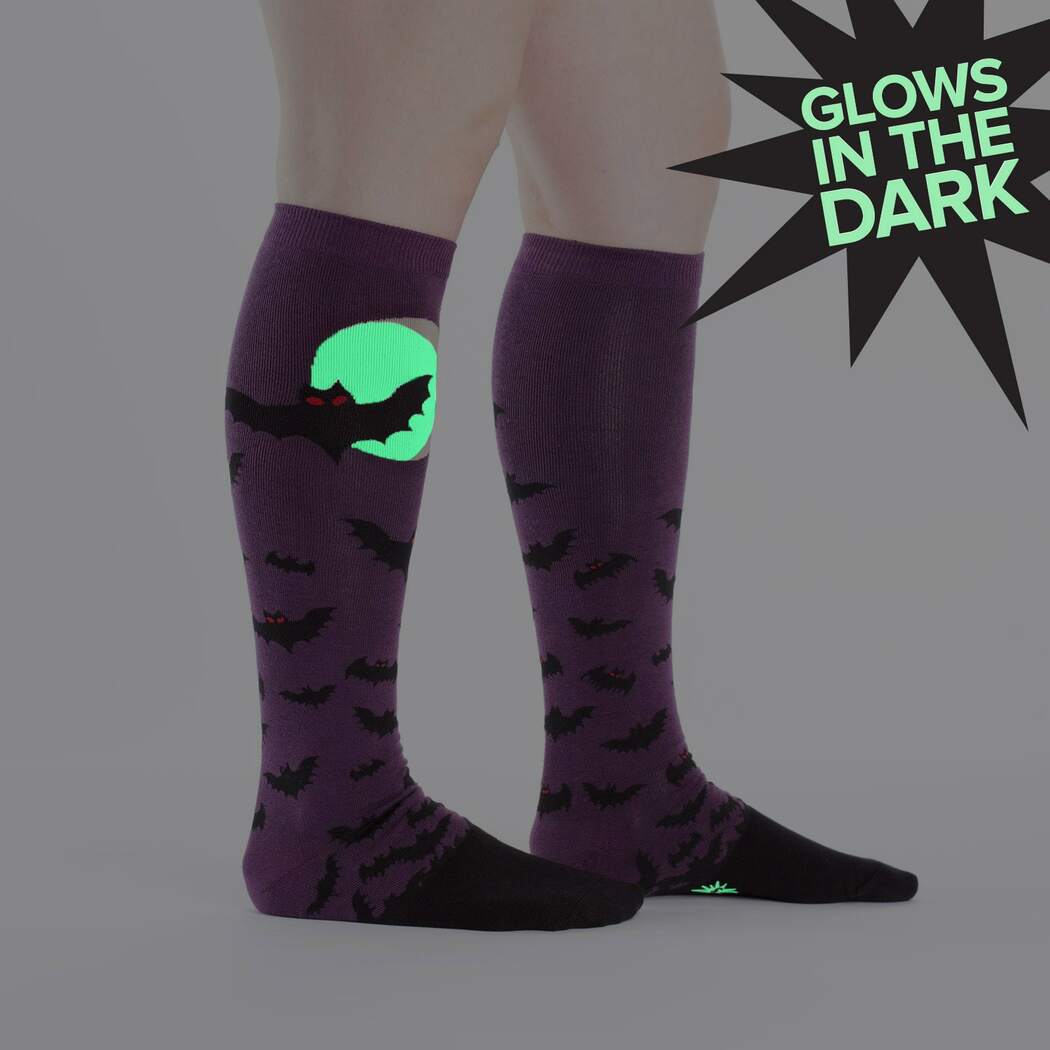Lifestyle shot showing the glow-in-the-dark Batnado socks on a person's legs.