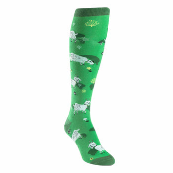 Knee-high socks, bright green background, white goats and green bushes pattern. Playful and whimsical design.