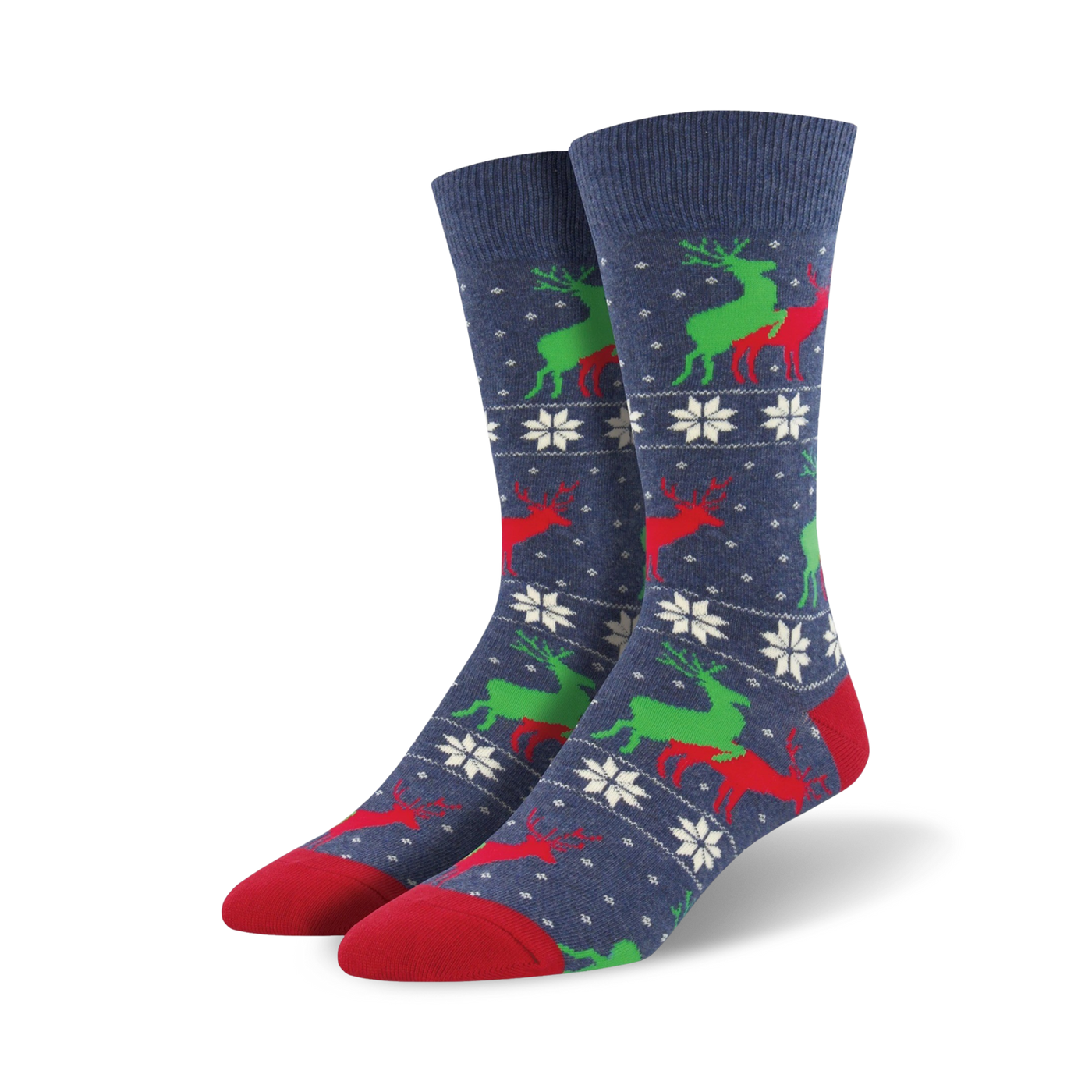 A pair of navy blue crew socks with a repeating pattern of red and green reindeer and white snowflakes. The socks have red toes and heels.