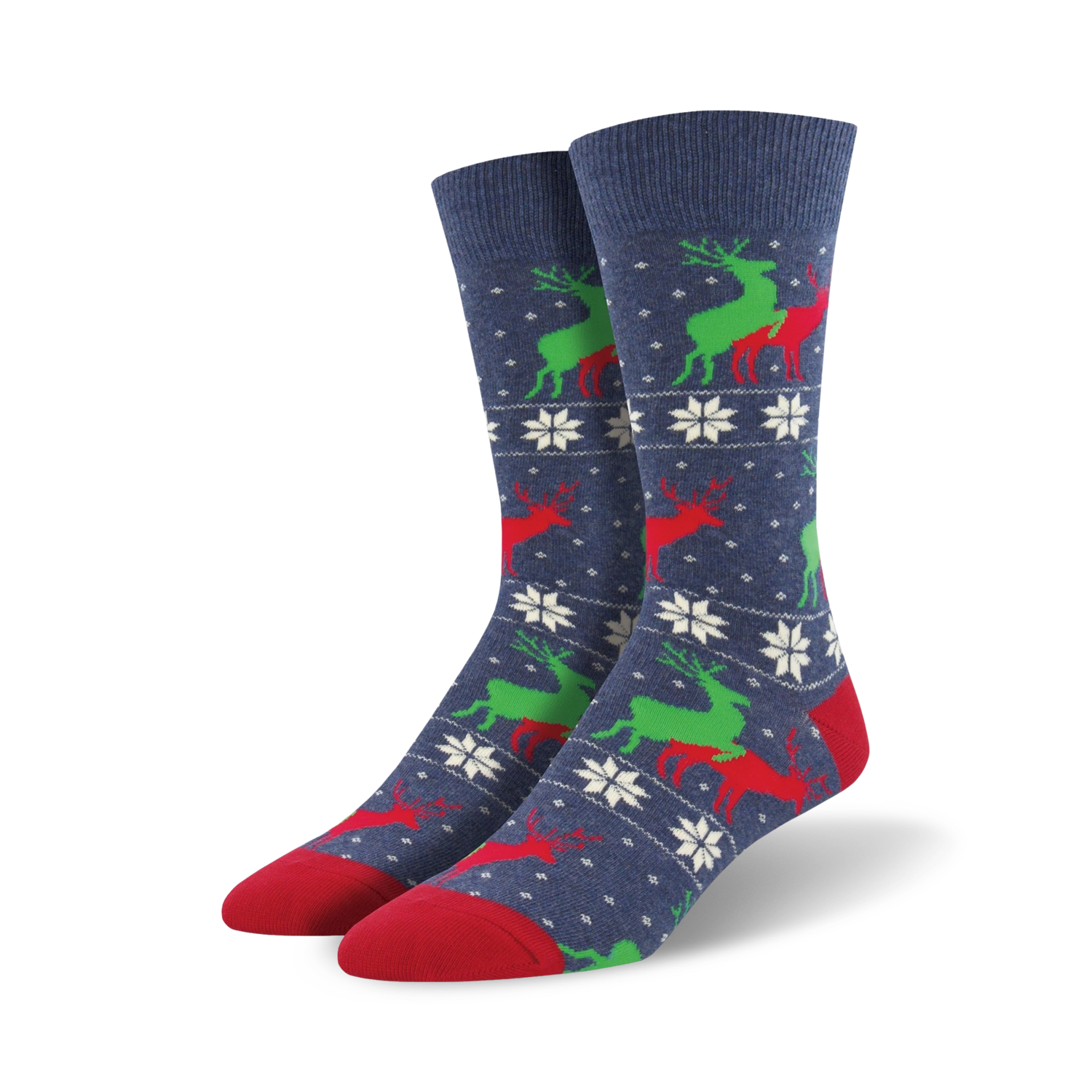 A pair of navy blue crew socks with a repeating pattern of red and green reindeer and white snowflakes. The socks have red toes and heels.