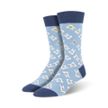 Pair of light blue crew socks with a pattern of happy and slightly unhappy white teeth. Navy blue cuffs.