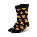 A pair of black crew socks with a repeating pattern of illustrated pieces of toast and butter. 