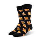A pair of black crew socks with a repeating pattern of illustrated pieces of toast and butter. 