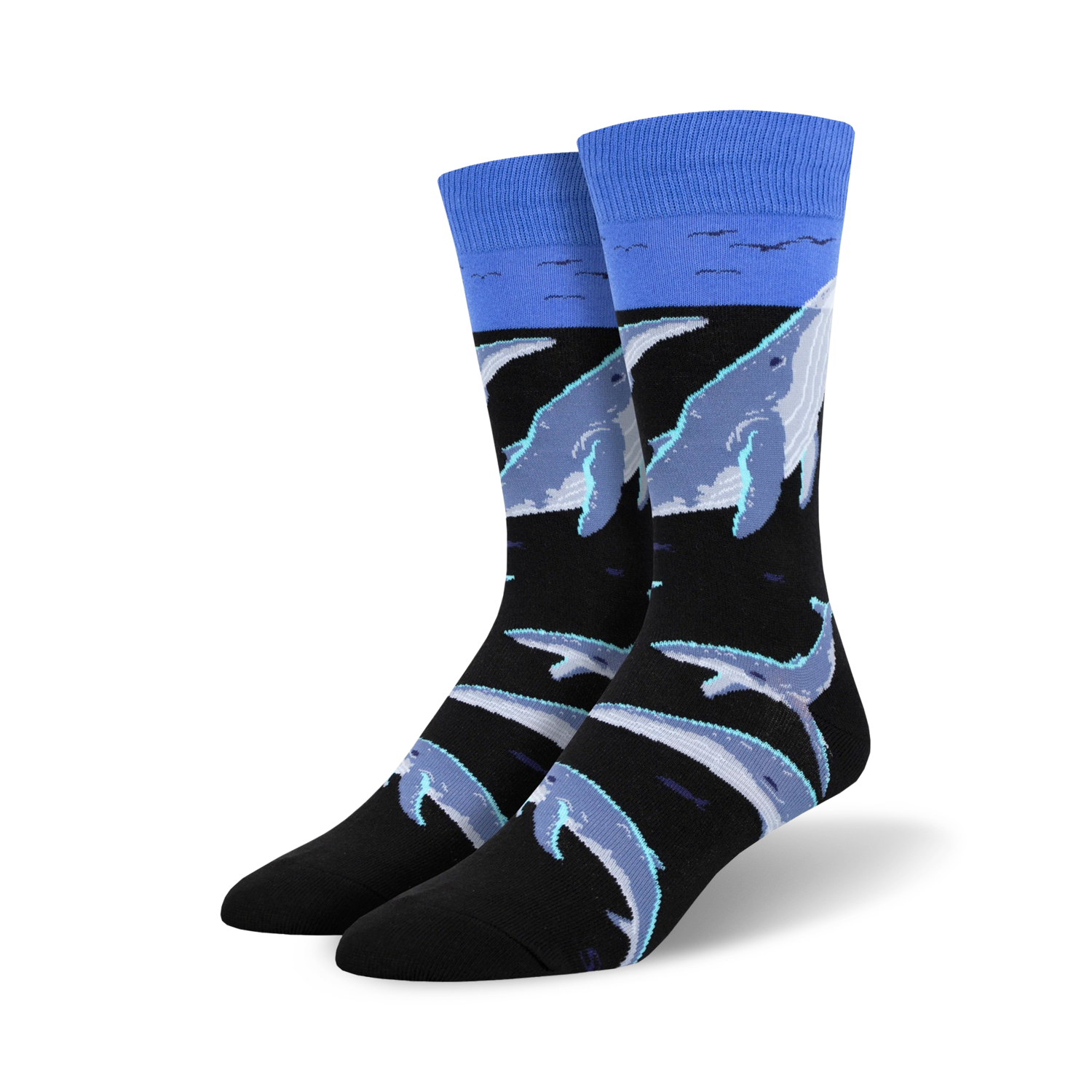 Crew socks featuring a black background with light blue and grey whales swimming. A light blue band at the top represents the ocean surface.